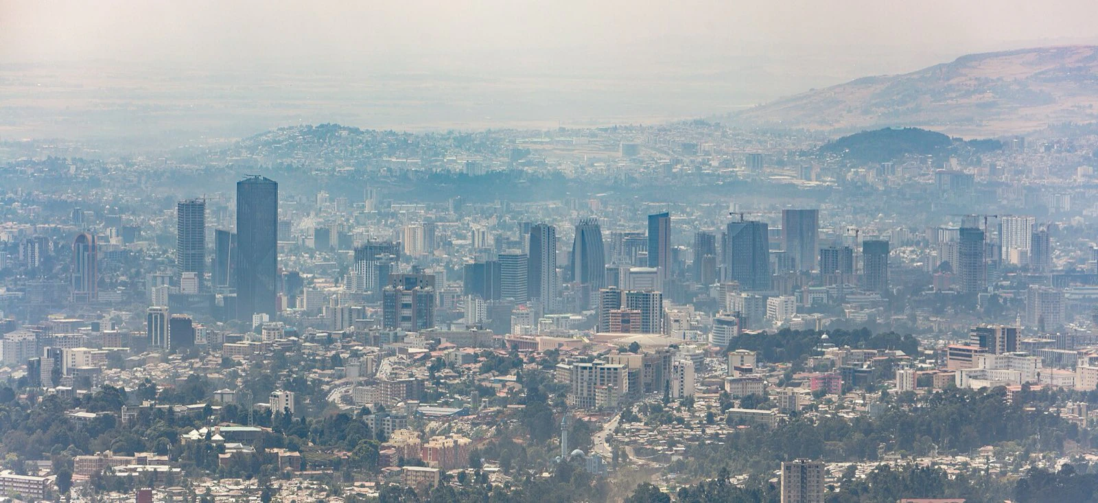 A wide view from Mount Entoto over the buildings and hills of Addis Ababa